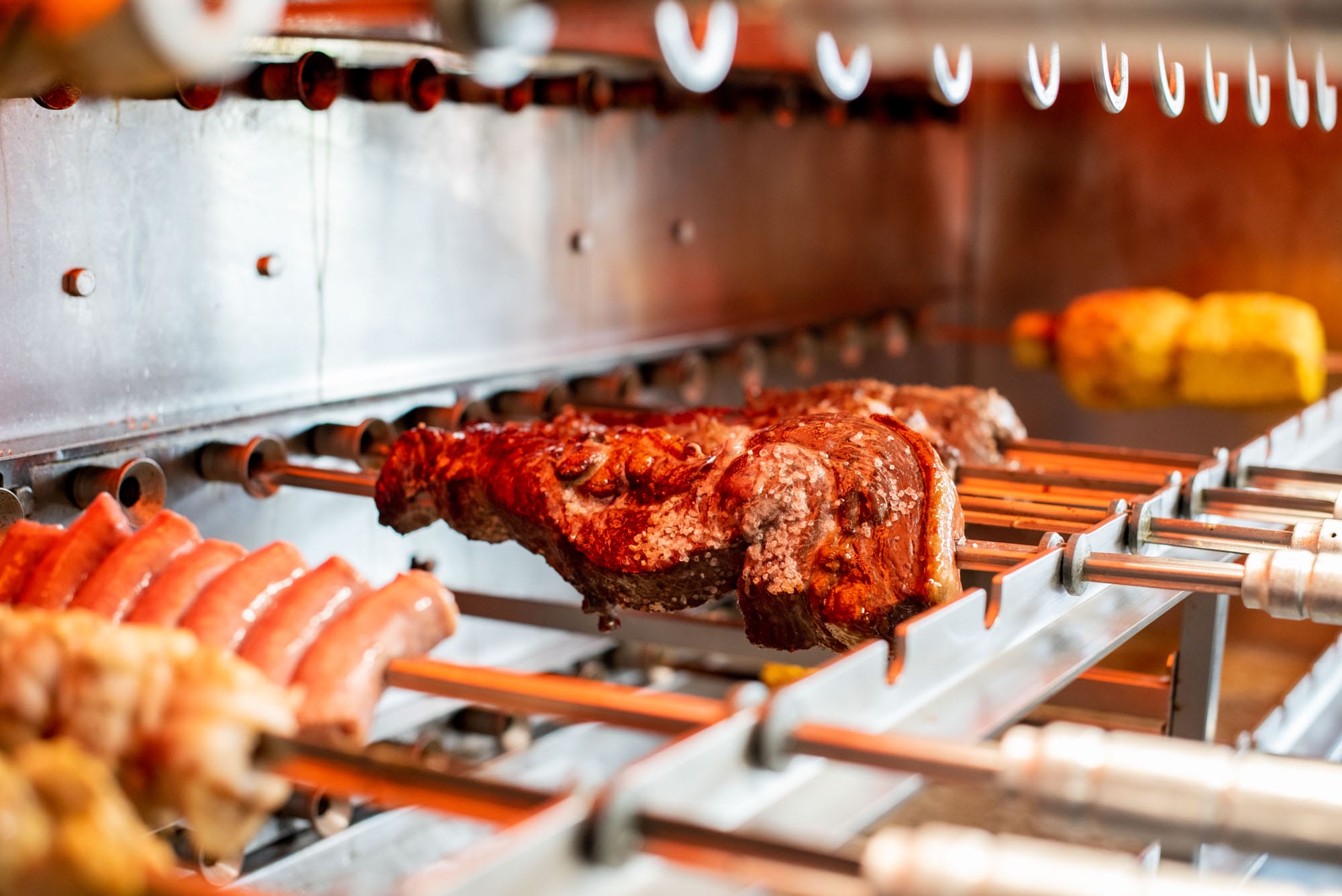 meats cooking over an open flame
