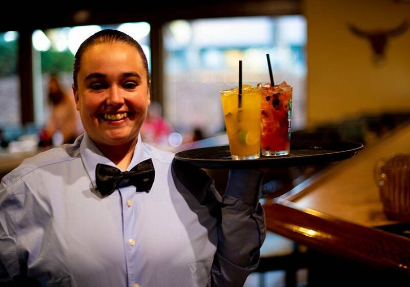 server with cocktail drinks at Boiada Brazilian Grill